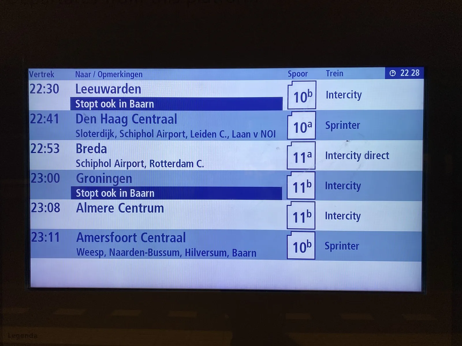 There are many time stamps in this picture of a display in a train. They all refer to times when trains in different direction will be leaving in the near future. Right now, according to the time in the top right corner, it is 22:28.