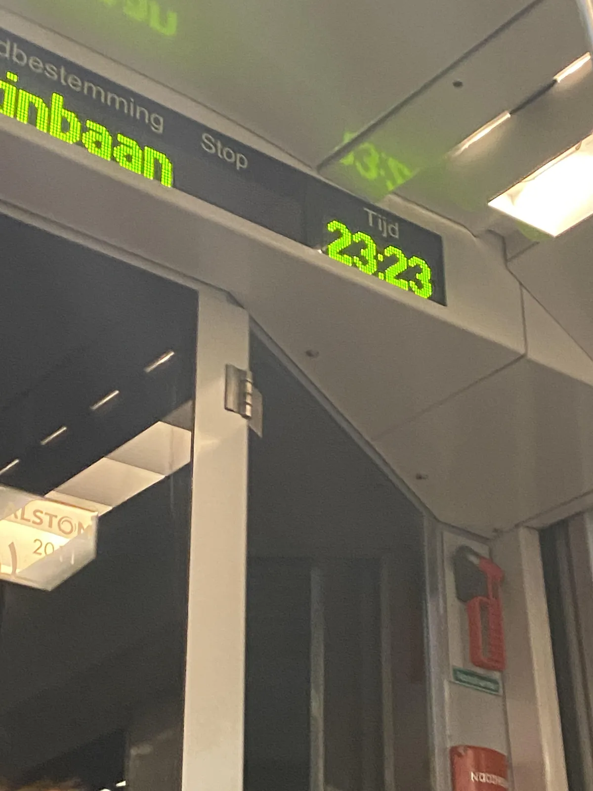 The time is shown in bright lime green numbers in this digital display. It says it is 23:23.s