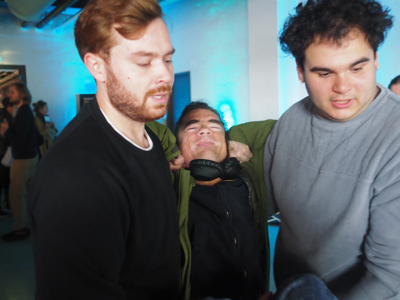 Marijn in the middle, lifted by two people.